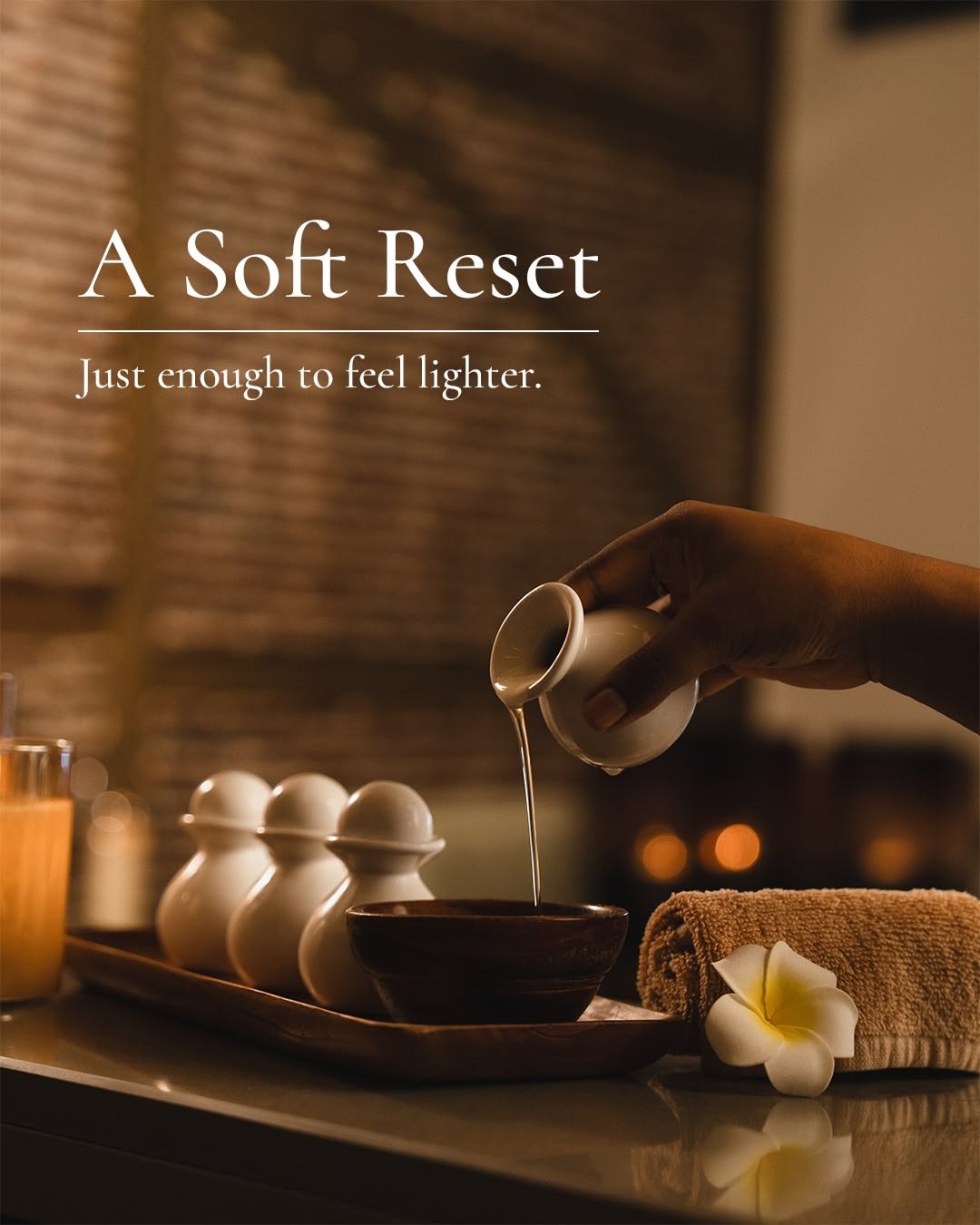 Spa flatlay with towels, stones and jasmine flower